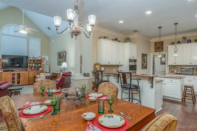 dining area with dark hardwood / wood-style floors, ceiling fan with notable chandelier, decorative columns, lofted ceiling, and ornamental molding