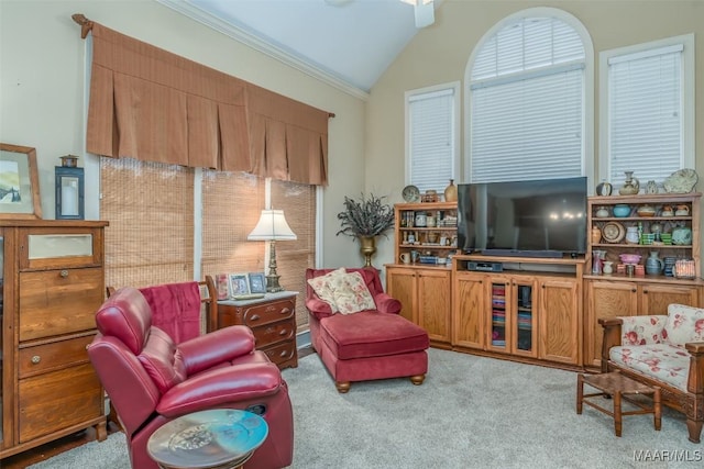 sitting room with crown molding, lofted ceiling, light carpet, and ceiling fan