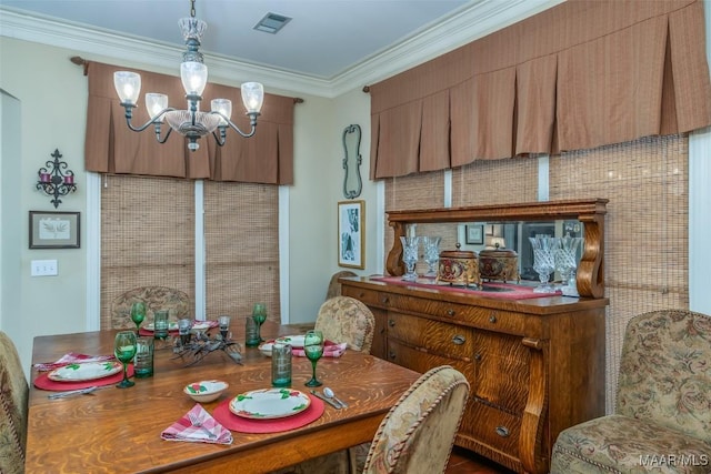 dining room featuring crown molding and an inviting chandelier