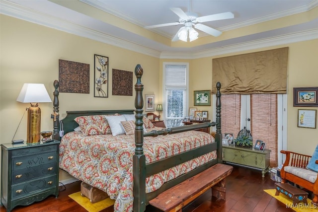 bedroom with crown molding, dark wood-type flooring, and ceiling fan