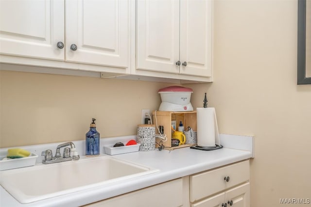 clothes washing area featuring sink