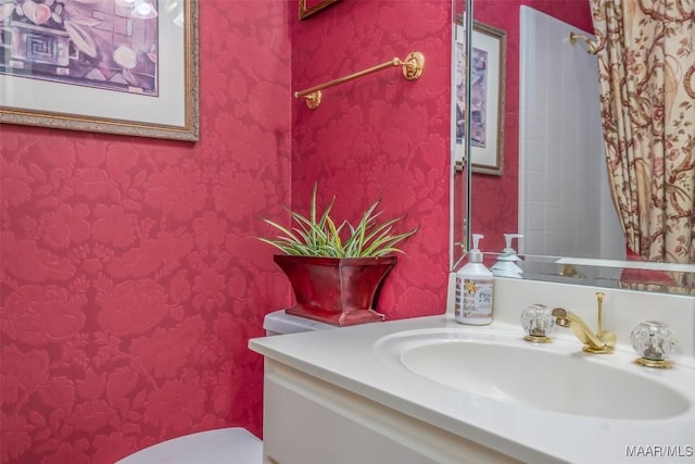 bathroom with vanity and toilet