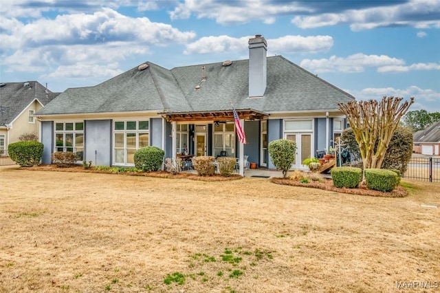 back of house featuring a lawn