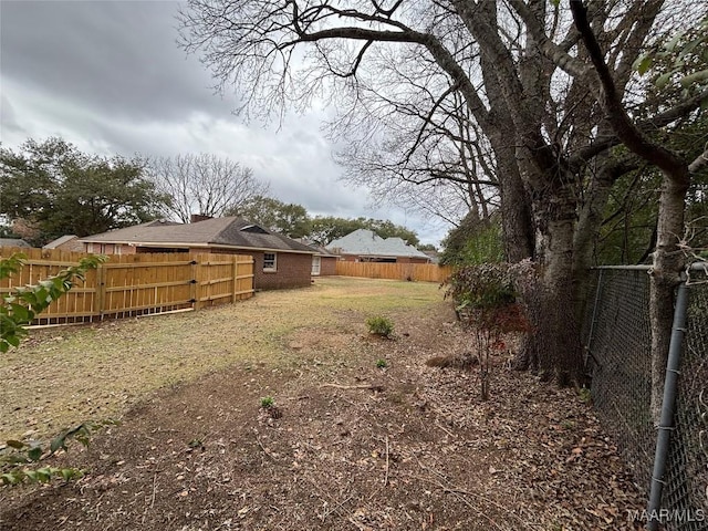 view of yard with a fenced backyard