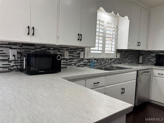 kitchen with sink, decorative backsplash, stainless steel dishwasher, and white cabinets