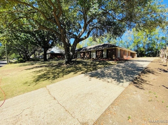 ranch-style house with a front lawn and driveway