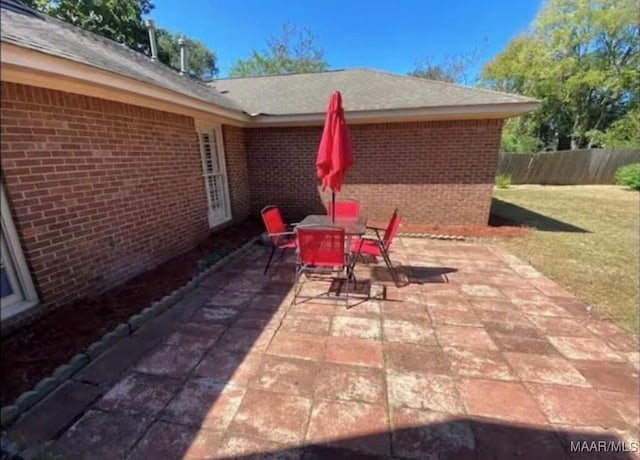view of patio with fence and outdoor dining space