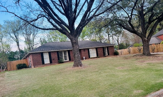 single story home featuring a front yard and fence