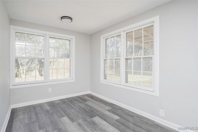 unfurnished dining area with dark wood-type flooring