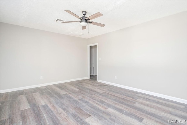 spare room featuring ceiling fan, a textured ceiling, and light hardwood / wood-style floors