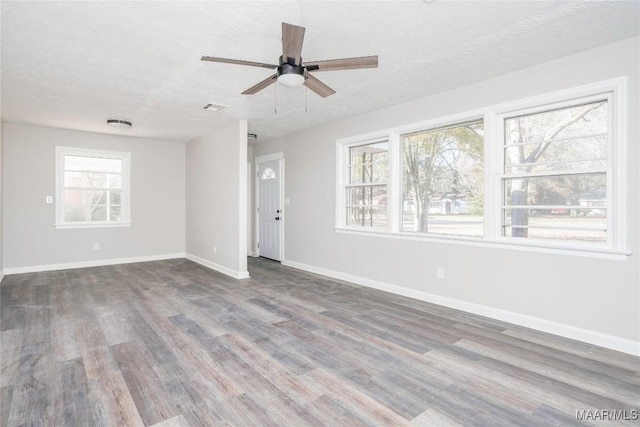 unfurnished room with hardwood / wood-style floors, a textured ceiling, and ceiling fan