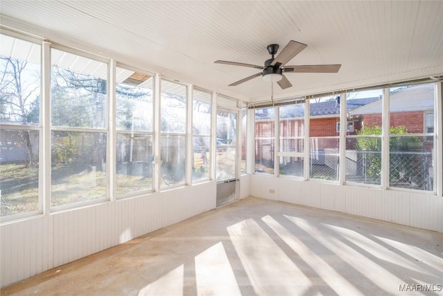 unfurnished sunroom with ceiling fan