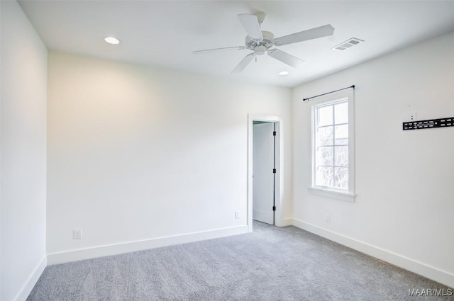 empty room with recessed lighting, carpet flooring, visible vents, and baseboards