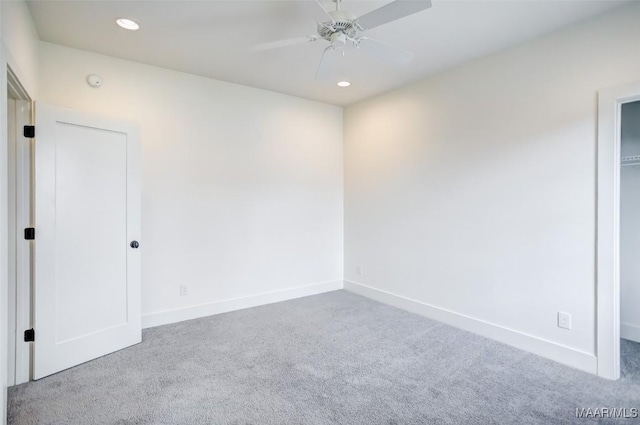 carpeted spare room featuring recessed lighting, ceiling fan, and baseboards