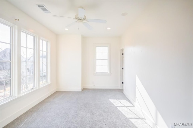 empty room featuring baseboards, visible vents, light colored carpet, ceiling fan, and recessed lighting