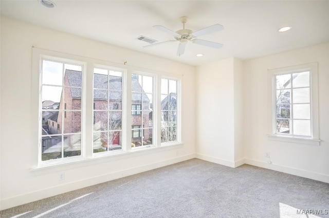 unfurnished room featuring recessed lighting, light colored carpet, visible vents, ceiling fan, and baseboards