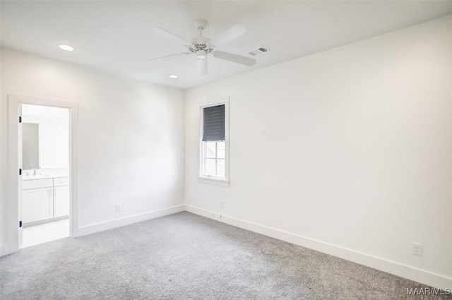 carpeted spare room with a ceiling fan, recessed lighting, visible vents, and baseboards