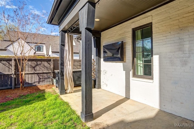 view of patio featuring fence