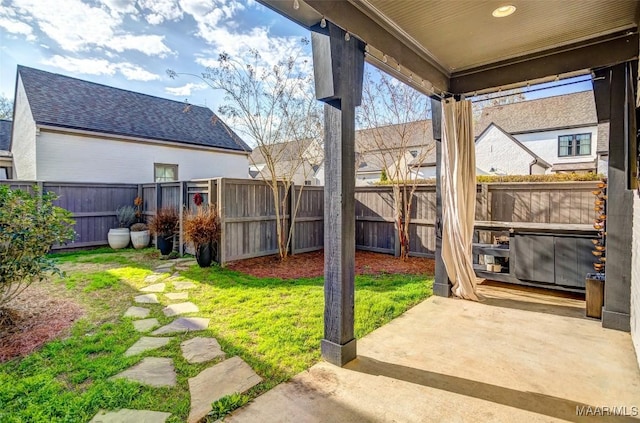 view of yard with a fenced backyard and a patio