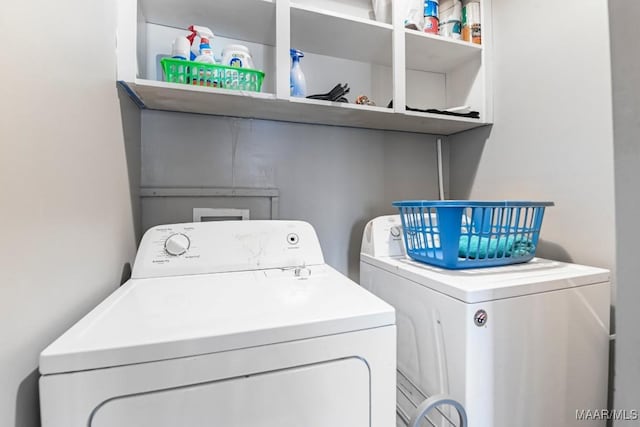 clothes washing area featuring washer and dryer