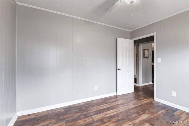 unfurnished room featuring dark hardwood / wood-style flooring, crown molding, and ceiling fan