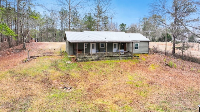 view of front of house with covered porch and a front yard