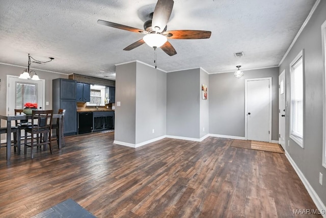 unfurnished living room with dark wood-type flooring, a healthy amount of sunlight, and a textured ceiling