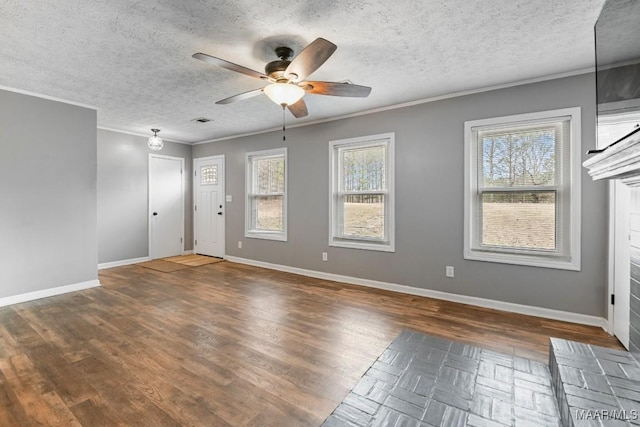 unfurnished room featuring crown molding, dark wood-type flooring, ceiling fan, and a textured ceiling