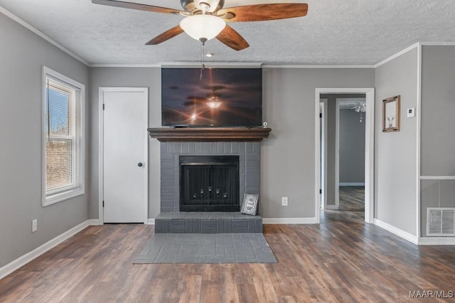 unfurnished living room featuring dark hardwood / wood-style flooring, crown molding, a fireplace, and a textured ceiling