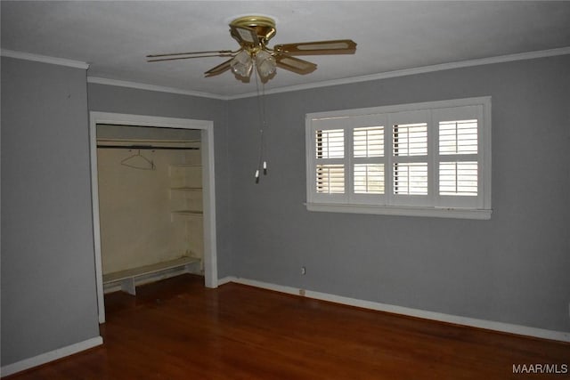 unfurnished bedroom featuring crown molding, dark wood-type flooring, ceiling fan, and a closet