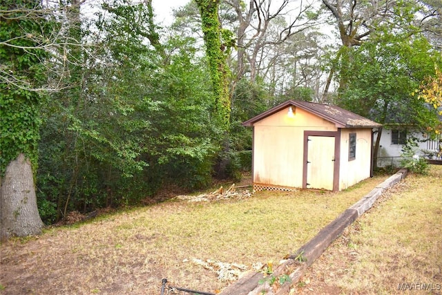 view of outdoor structure featuring a lawn