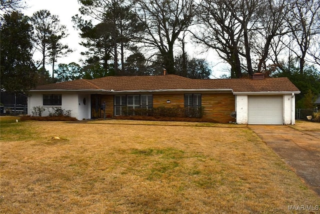 ranch-style house with a garage and a front lawn