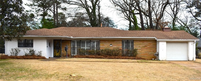 ranch-style home featuring a garage and a front yard