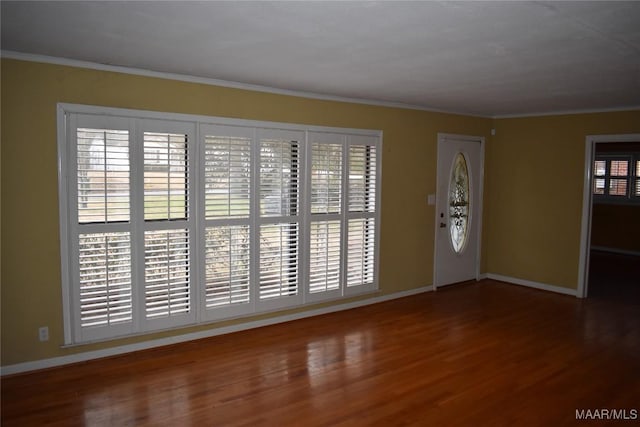 entrance foyer featuring hardwood / wood-style floors and crown molding