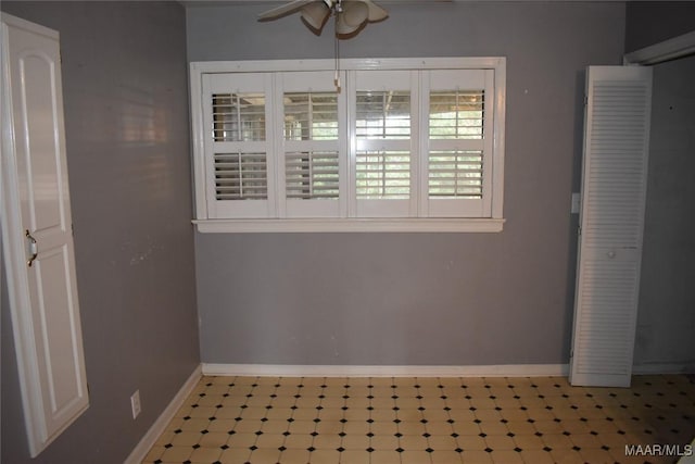 interior space with ceiling fan