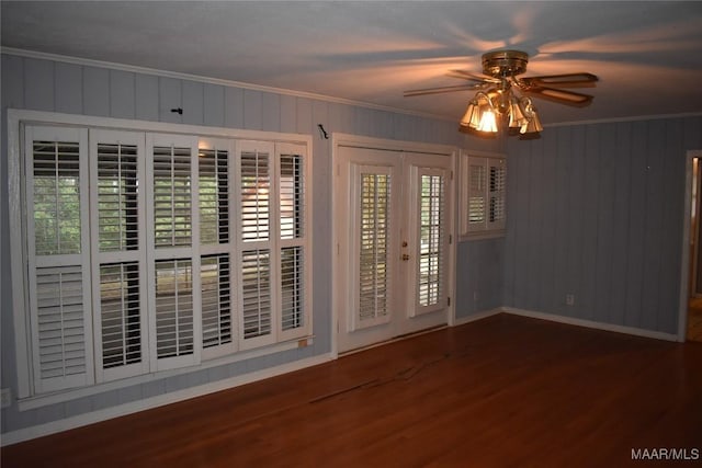 empty room featuring crown molding, ceiling fan, french doors, and hardwood / wood-style flooring