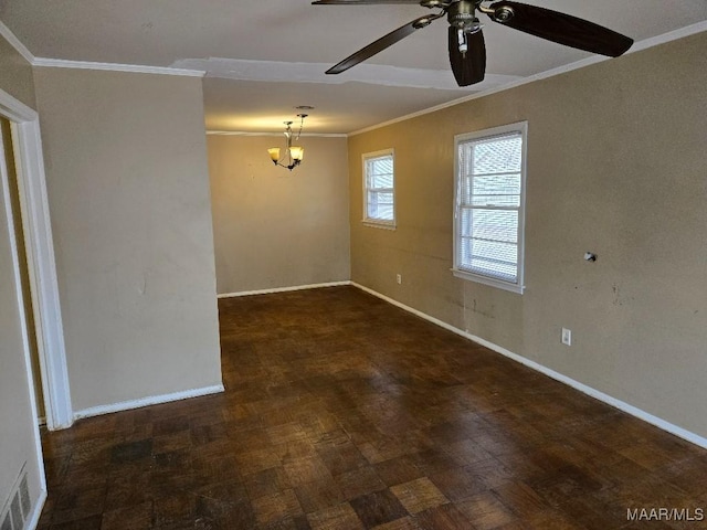 empty room featuring crown molding and ceiling fan with notable chandelier