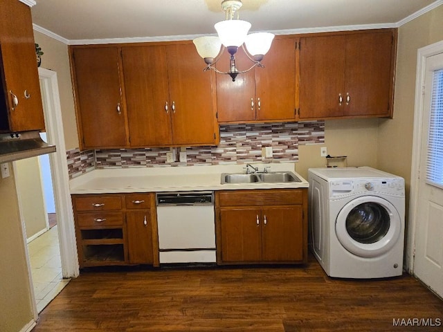 clothes washing area with dark hardwood / wood-style flooring, washer / clothes dryer, ornamental molding, and sink