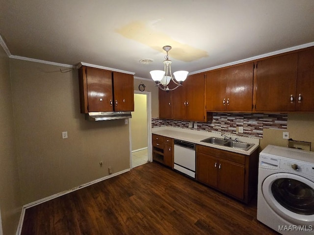 kitchen featuring washer / dryer, sink, hanging light fixtures, a notable chandelier, and white dishwasher