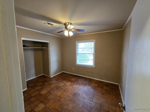 unfurnished bedroom with ornamental molding, a closet, and ceiling fan