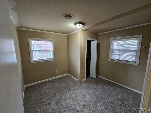 unfurnished bedroom featuring ornamental molding and dark colored carpet