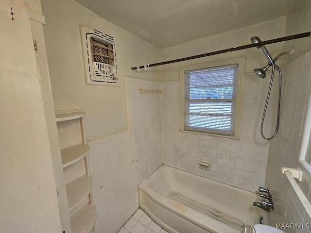 bathroom with tile patterned flooring, tiled shower / bath, and tile walls