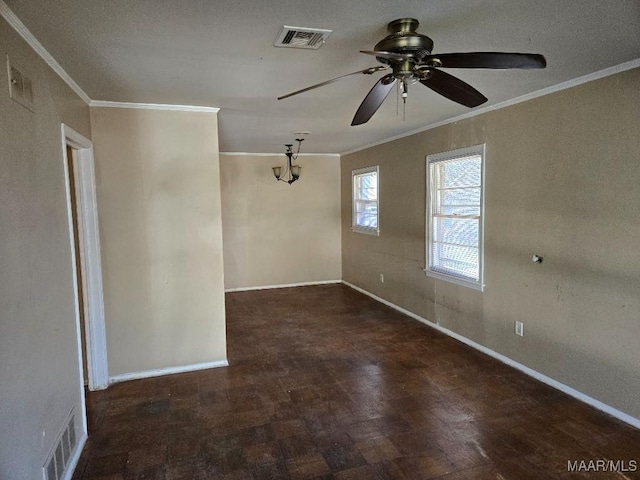 spare room featuring ornamental molding, visible vents, and baseboards