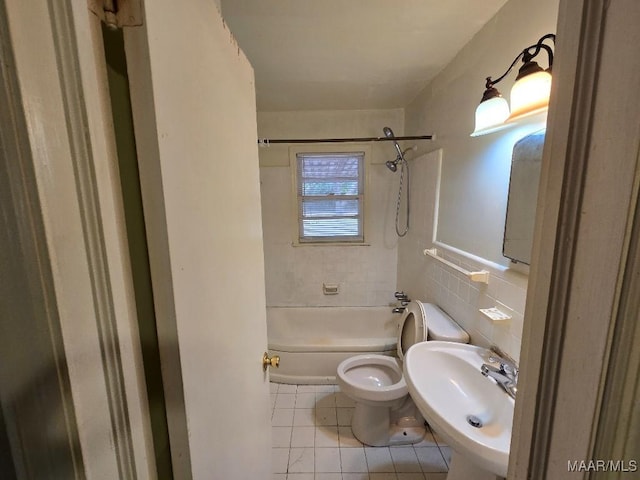 bathroom featuring tile walls, toilet, tub / shower combination, a sink, and tile patterned floors