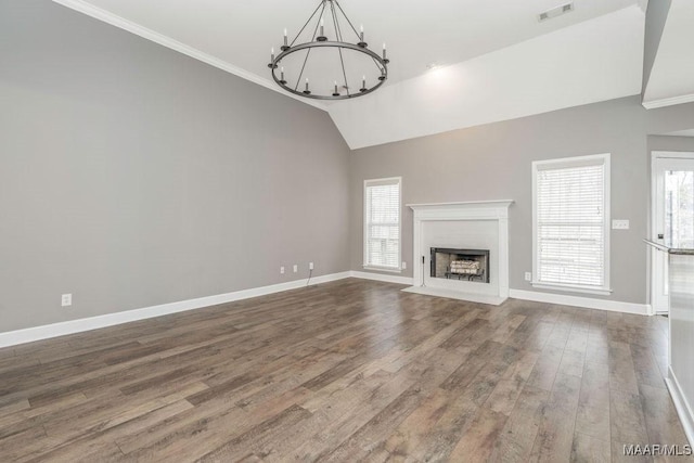 unfurnished living room featuring wood-type flooring, vaulted ceiling, ornamental molding, and an inviting chandelier