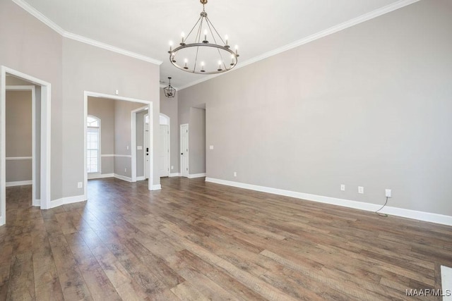 unfurnished dining area with wood-type flooring, ornamental molding, and a notable chandelier