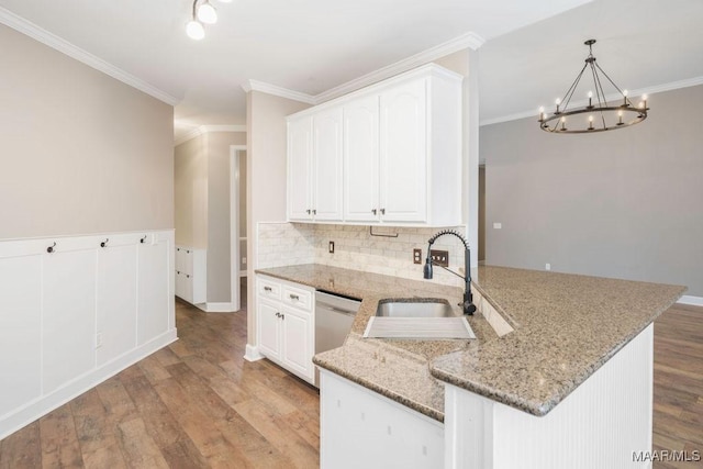 kitchen with sink, white cabinets, stainless steel dishwasher, kitchen peninsula, and light hardwood / wood-style flooring