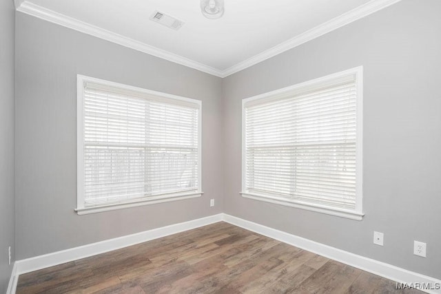 spare room with wood-type flooring and ornamental molding