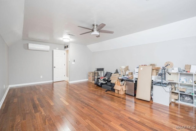 interior space featuring wood-type flooring, lofted ceiling, ceiling fan, and a wall unit AC