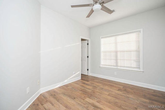 empty room featuring wood-type flooring and ceiling fan